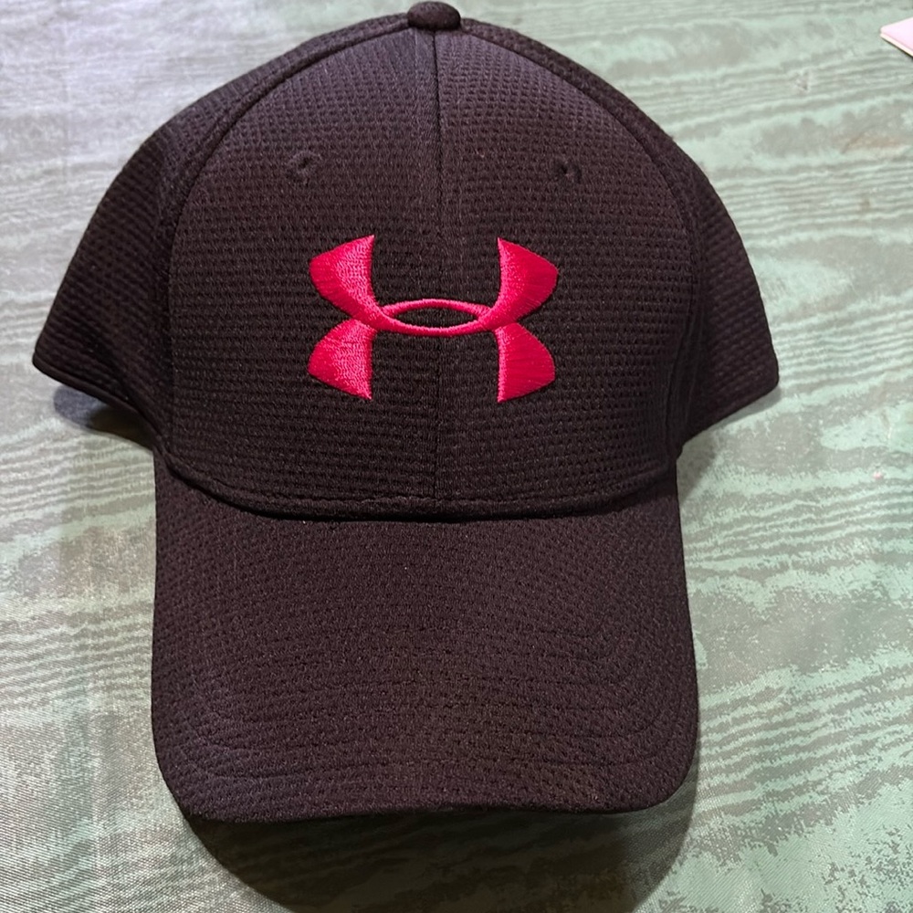 Under Armour black cap with a hot pink logo on it. Never worn.